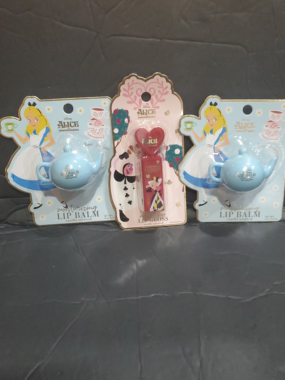 Disney’s Alice in Wonderland 3pack vanilla lip gloss and blue teapot lip balms